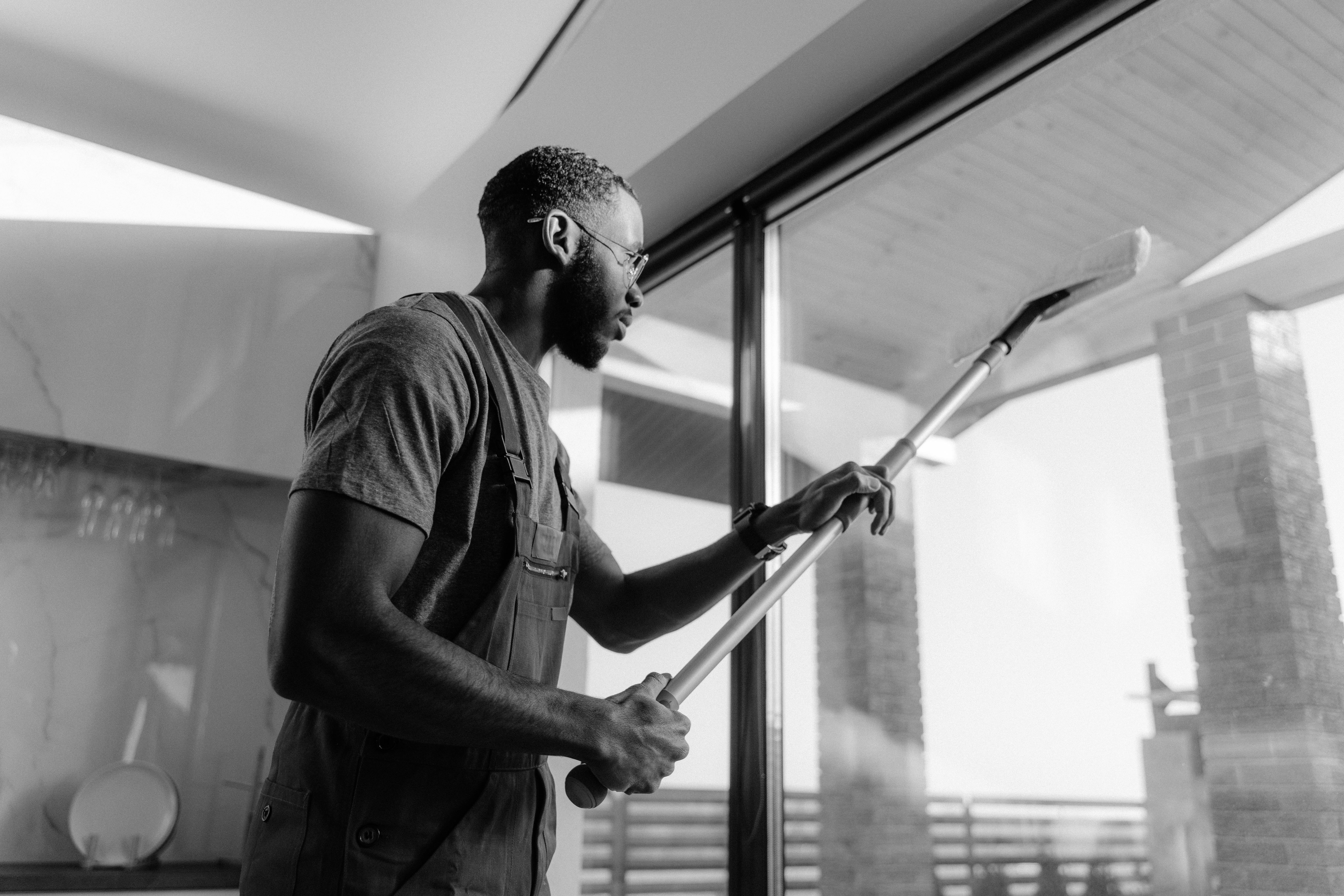 a person cleaning window glass